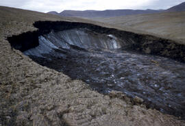 Close example of hill side erosion due to melting of ice in soil.