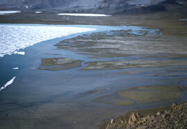 A very large river delta of water and eroded soil materials entering the sea. Tue sea ice at this...