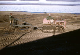 Isachsen community. Workers preparing ground for a building construction. Note a musk ox in the d...