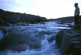 Our guide Kolout looking over a fast moving stream.