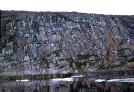 Extremely high cliffs facing into the sea. Granite type material.