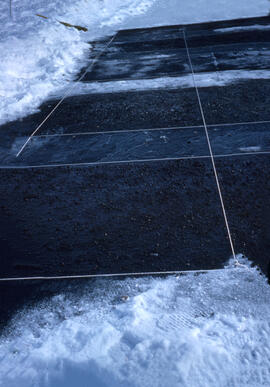 Close- up slide of various black materials melting the sea ice from rays of sun