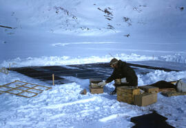 Denis St Onge working on dirt sea ice experiment off the coast of Isachsen